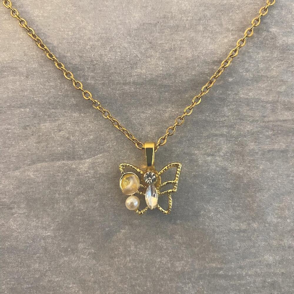 Butterfly pendant necklace with faux pearl and rhinestone details